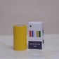 Yellow roll of tape and its packaging box on a light surface with a neutral background